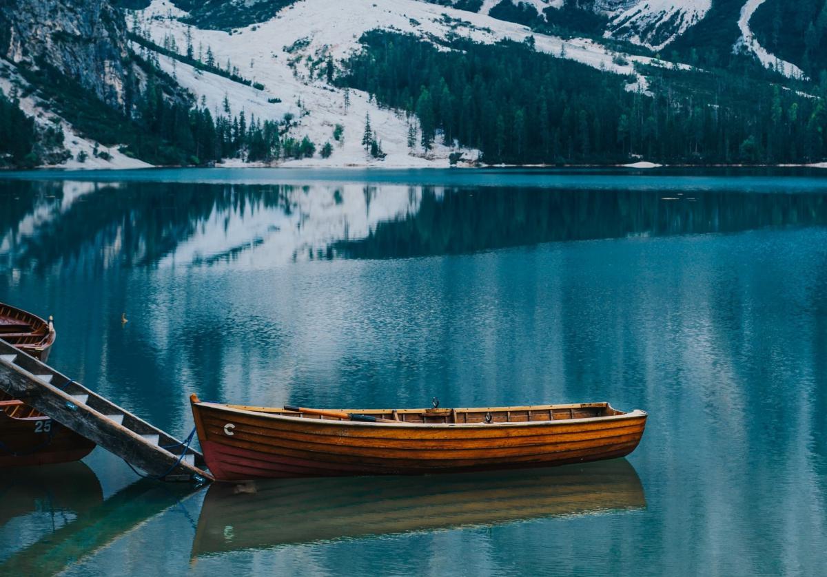 On a lake in the Rocky Mountains of Colorado, a single wooden canoe offers protection fron the cold, winter waters below. 